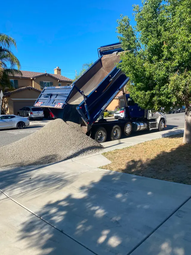 Dump truck delivering base rock for a landscaping job in Perris, CA
