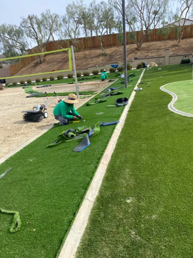 Millenium crew seaming and cutting the turf edge on a job in Perris, CA