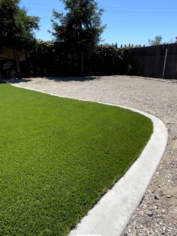 Artificial grass with a gravel border in a Perris, CA yard